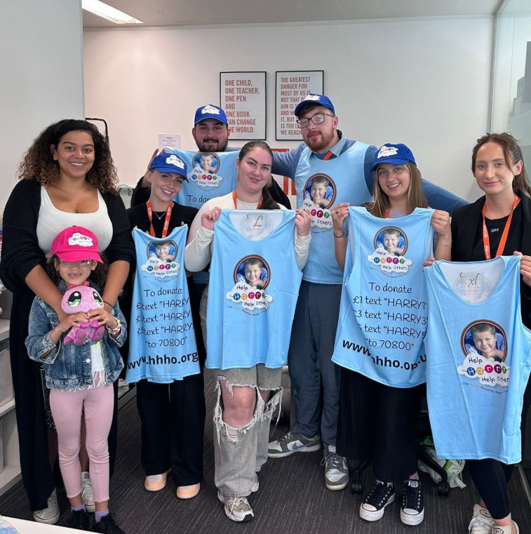 Members of the Smile Education team wearing Help Harry Help Others vests in preparation for a 5k inflatable run